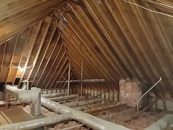 attic space being inspected for proper attic ventilation