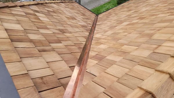 copper in an open valley on a cedar shake roof