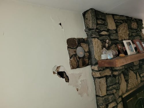 water damage to wall around fireplace from chimney leak