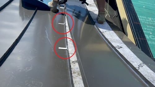 example of clips on a standing seam metal panel before installation