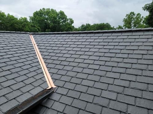 copper flashing in a valley on a synthetic slate shingle roof