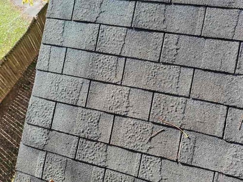 manufacturer defect on architectural asphalt shingles covered by roofing warranty