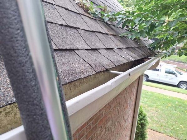 dents in the face of a gutter caused by hail damage