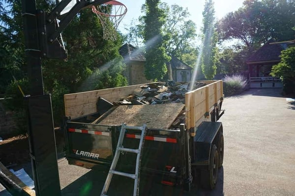 dump trailer with torn off roof debris