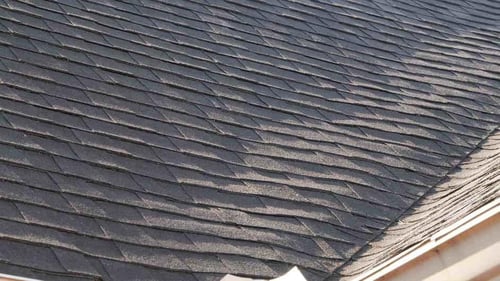curled and wavy shingles from improper installation
