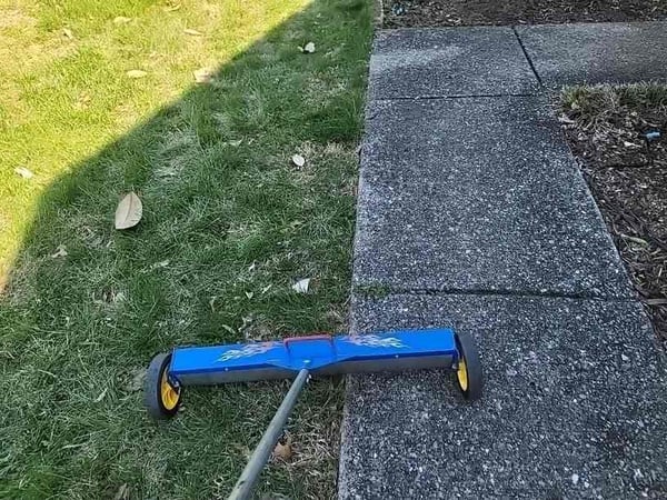 magnet going through grass to catch nails leftover from roof replacement 