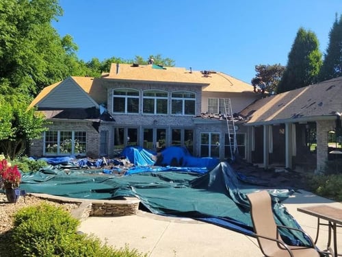 tarps and other protective measures covering property to prevent damage during a roof replacement