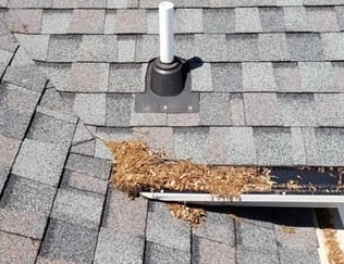 debris roof leak from debris in gutter that goes into a roof valley 