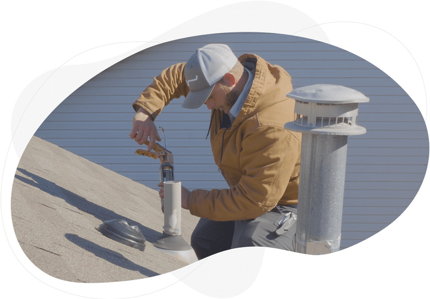 Professional roofer repairing an asphalt shingle roof