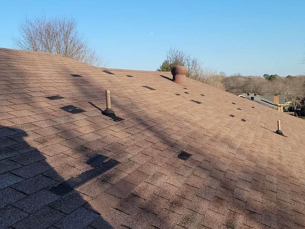 wind damaged roof with a lot of wear and tear