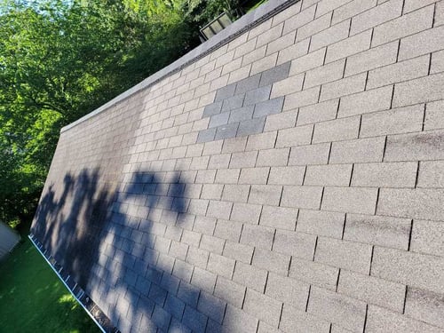 roof patch from missing shingles caused by wind damage