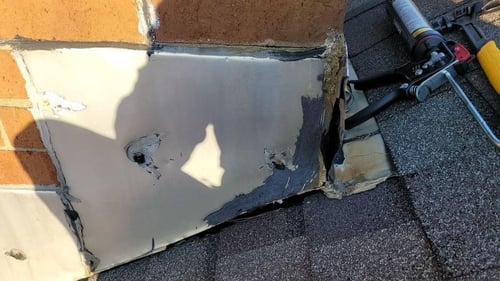 damaged and rusted roof flashing on chimney
