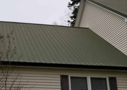 green screw down metal roof with color fading