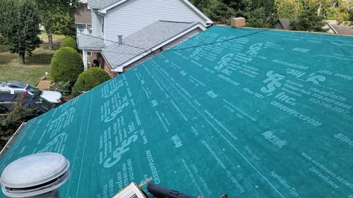 synthetic underlayment installed over roof decking before shingle installation begins