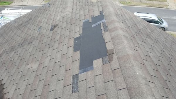 missing shingles on a 3 tab asphalt shingle roof caused by wind damage