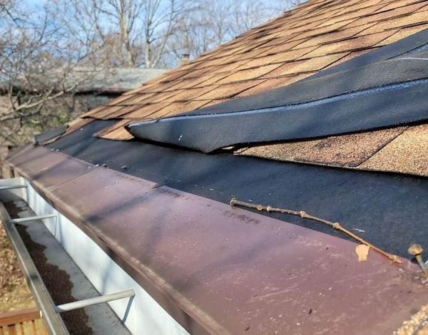 wind damage on asphalt shingle roof