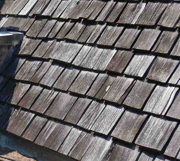 aged cedar shake shingles cracking and losing color